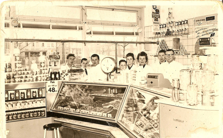 De winkel van Slagerij Mulder rond 1957. Herman en Jaap staan rechts van de weegschaal samen met hun ouders en personeel.  <p>Foto: Herman Mulder ©<br />
<em>Klik rechts bovenaan op de foto en de foto wordt vergroot weergegeven.</em></p>