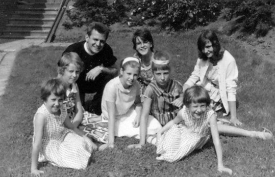 Pater Chris Tielemans met enkele meisjes van het jeugdkoor in de tuin van de kerk .<br />Foto: Trees Ruigrok v.d.Werve 