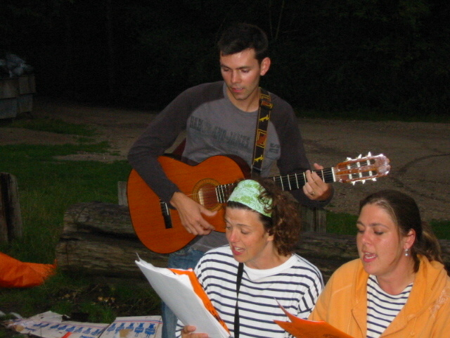 Zingen met de gitaar. Bij het kampvuur wordt natuurlijk gezongen. Iemand van de leiding speelt gitaar. 
