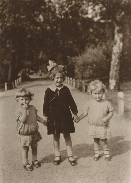 Tweeling Bora met haar tweeling zusje aan de hand van haar oudere zus in het Oosterpark 