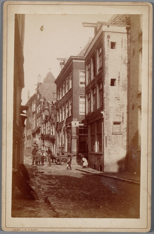 Foto van de Tweede Batavierdwarsstraat 1-13 gezien in de richting van Oudeschans, met rechts de ingang van de Batavierstraat, ca. 1910. Bron: Collectie Stadsarchief Amsterdam: kabinetfoto's.  